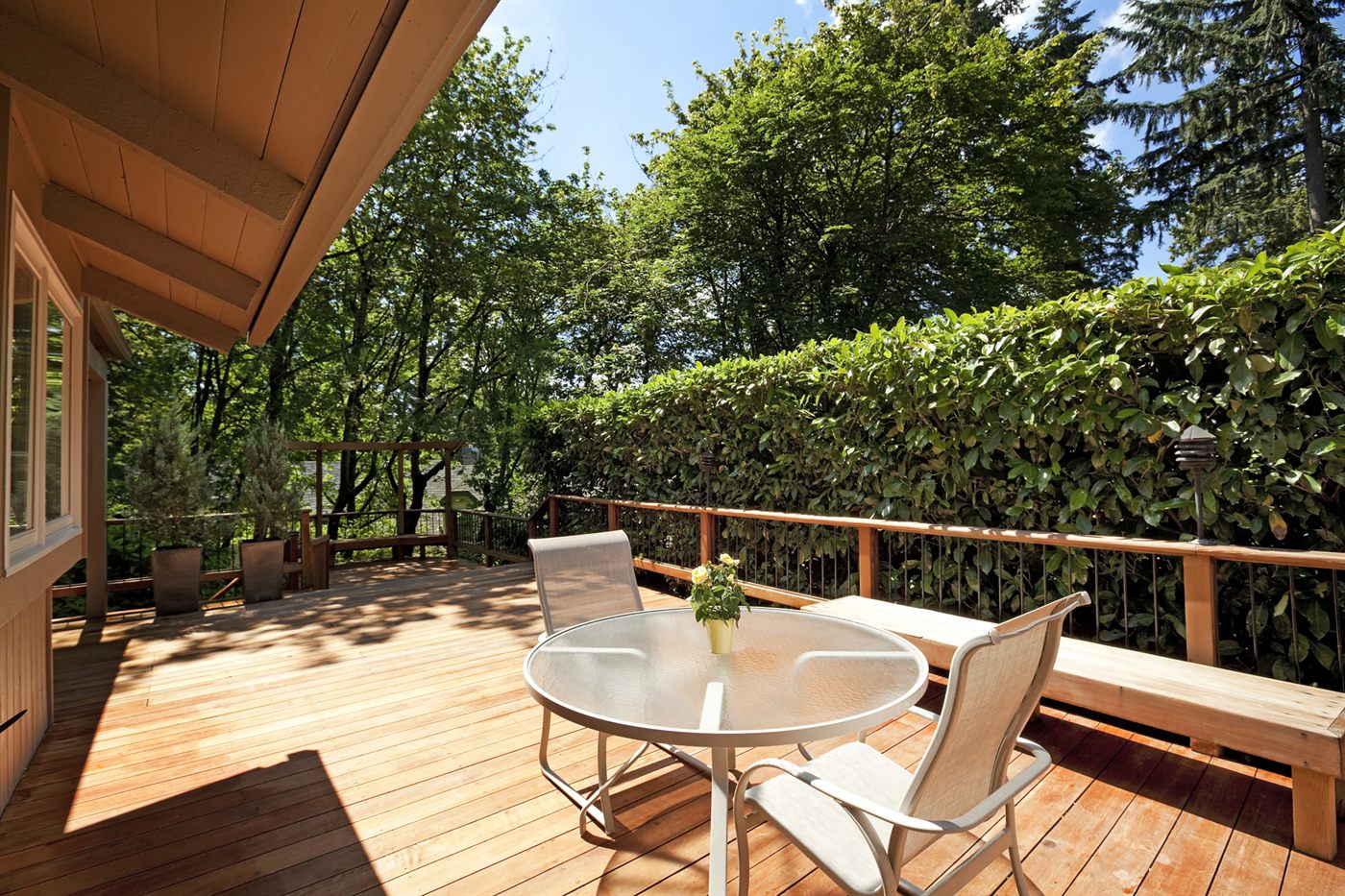 Custom wood deck overlooking a wooded backyard
