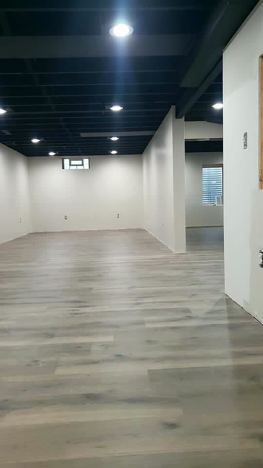 Basement after — finished living space with luxury vinyl plank flooring