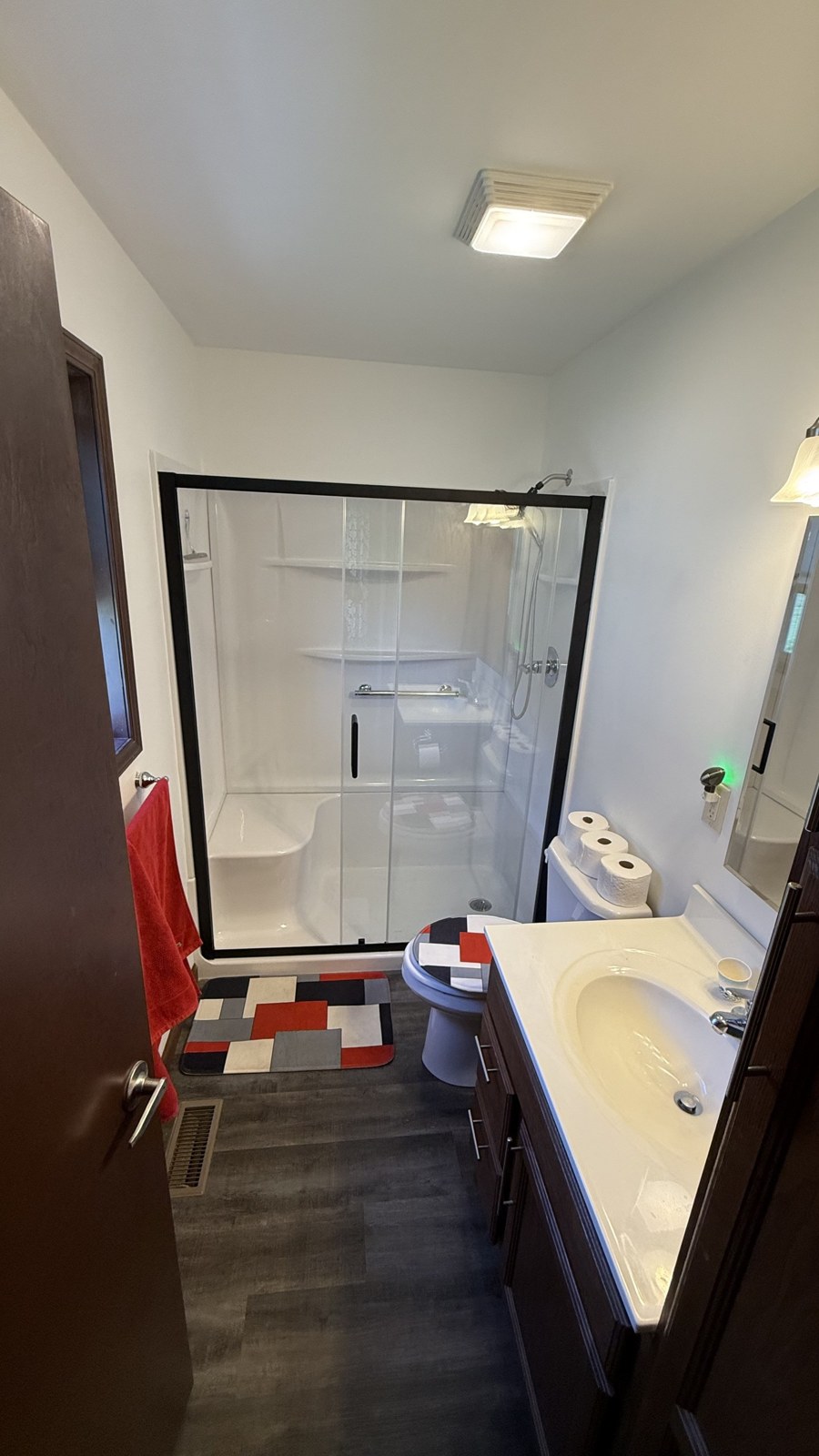 Finished bathroom with glass shower enclosure and vanity