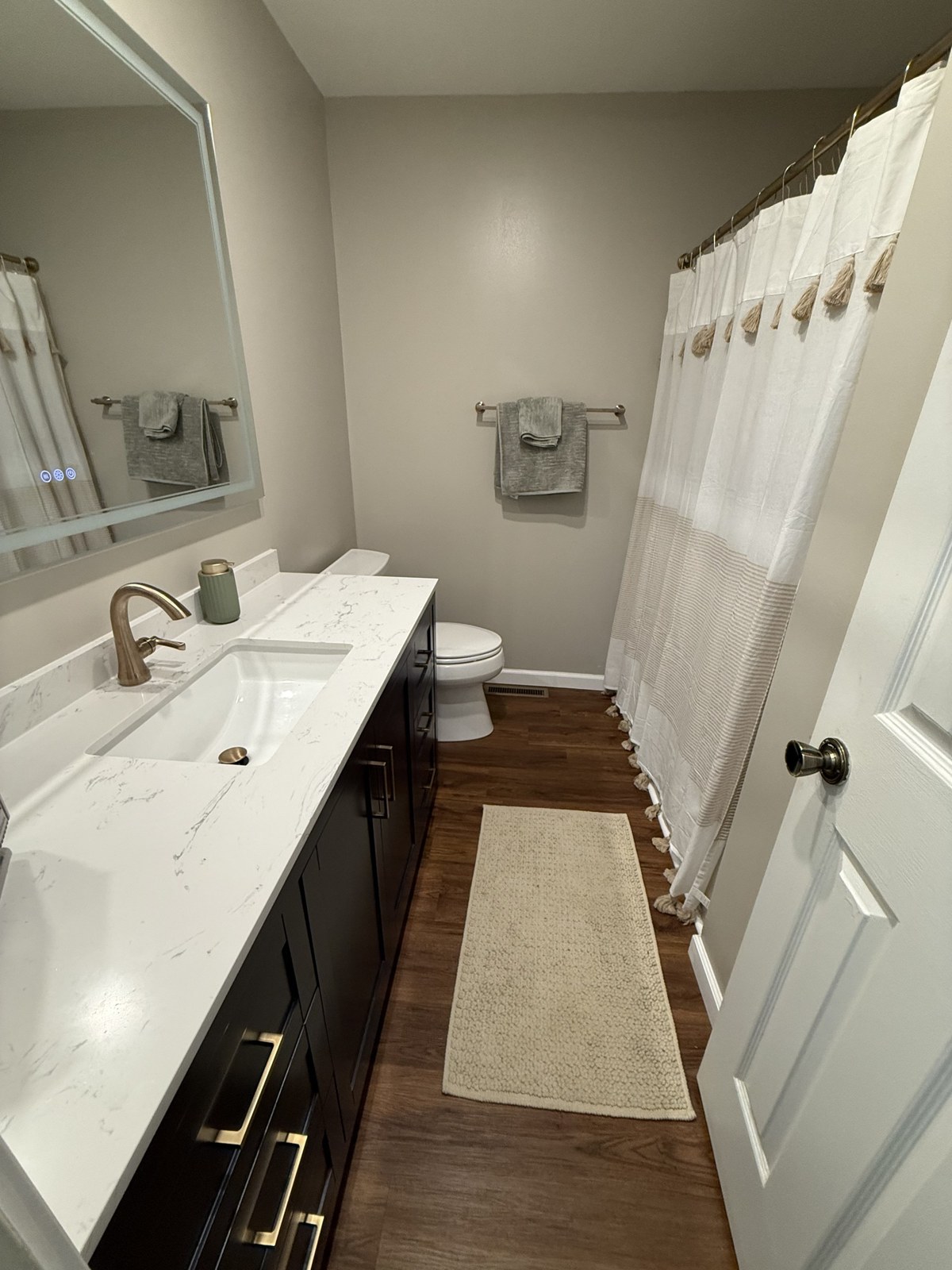 New vanity with framed mirror and updated lighting