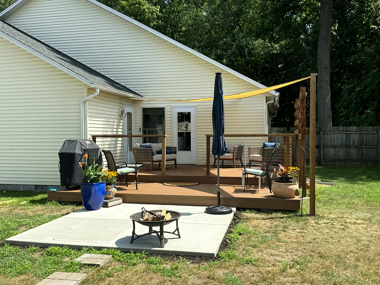 Finished deck and concrete patio outdoor living space