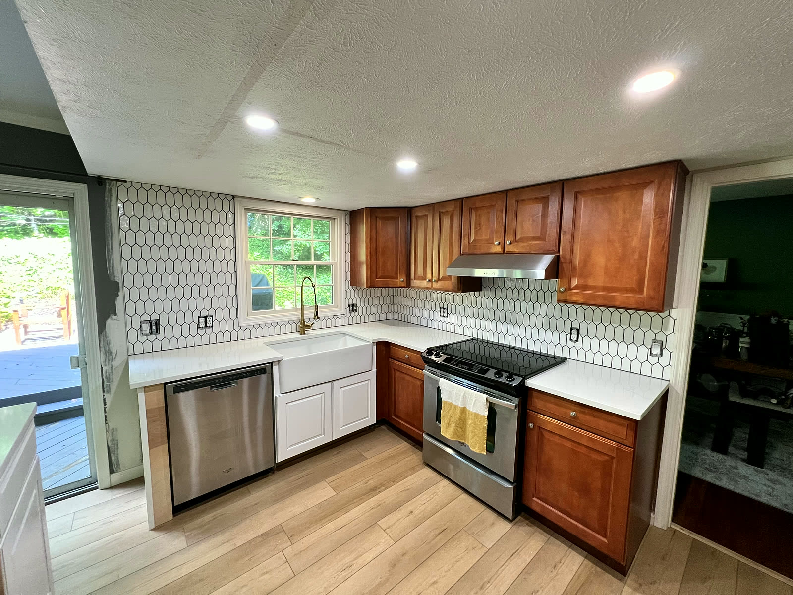 Wood cabinet kitchen with stainless appliances and gold fixtures