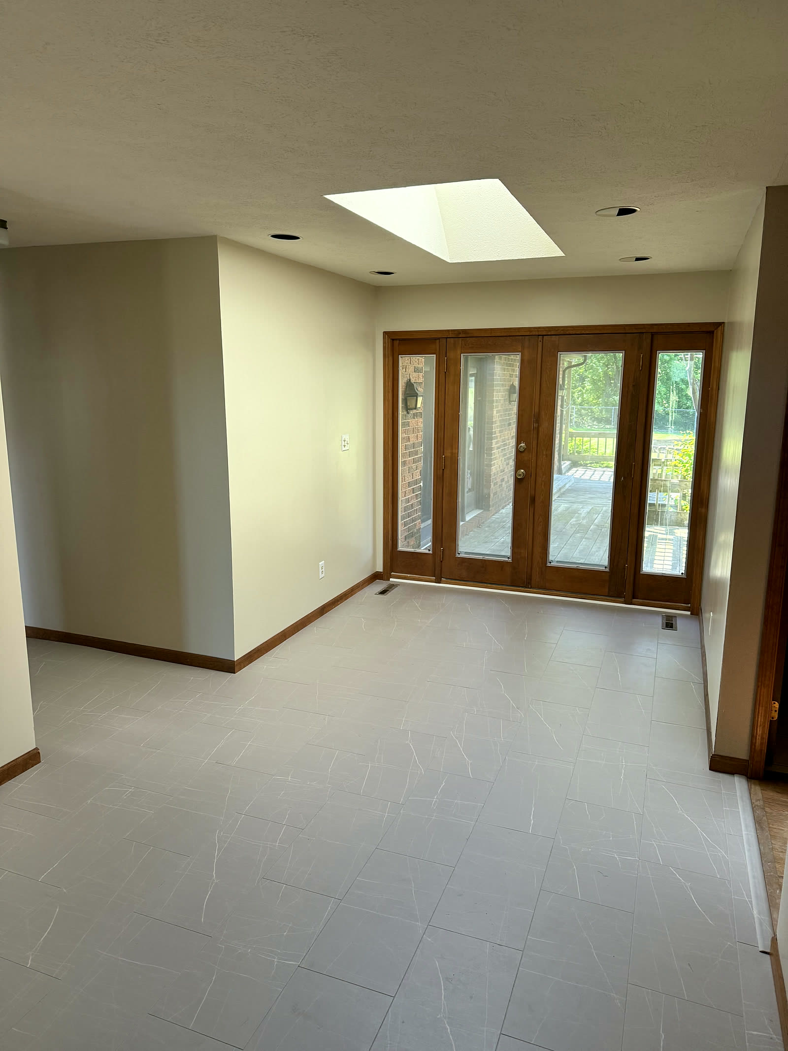 Open living area with French doors to the backyard