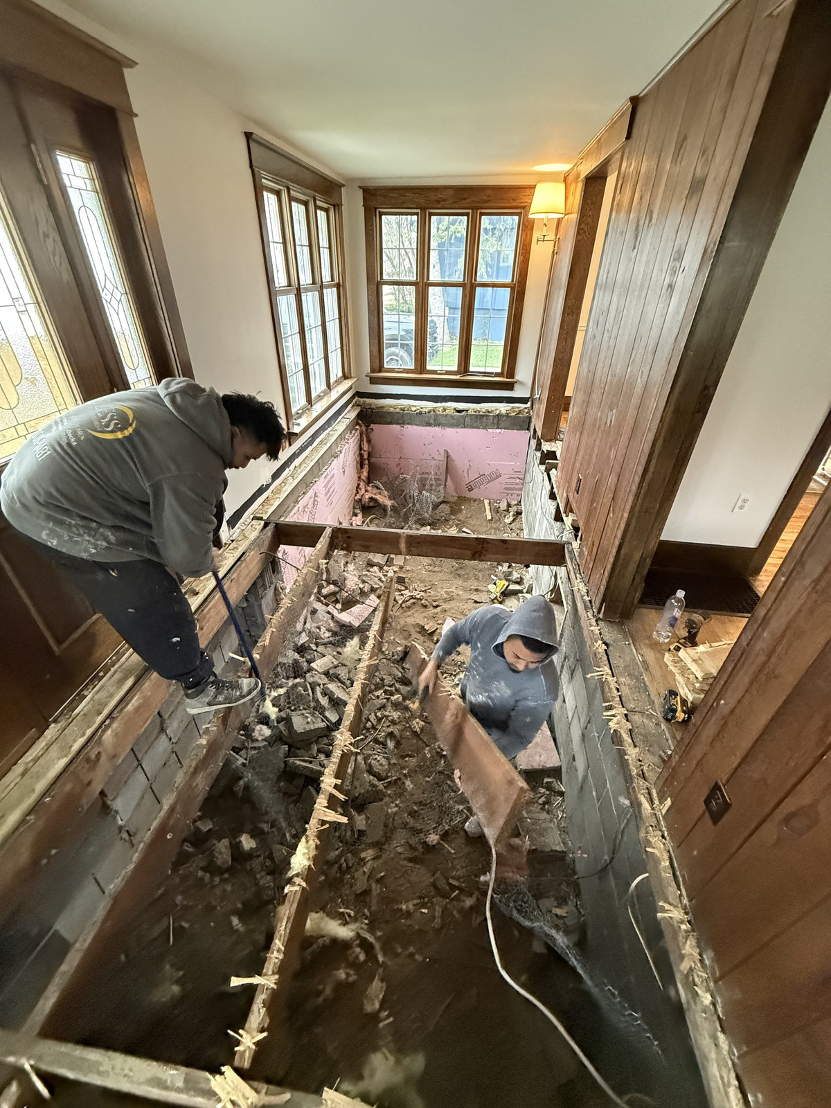 Crew removing a failed floor system down to the crawlspace
