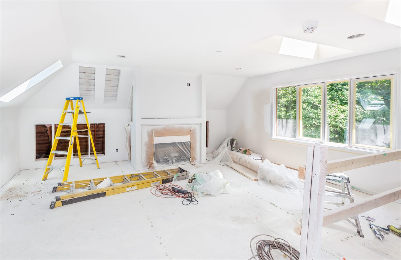 Interior remodel in progress with new framing and large windows