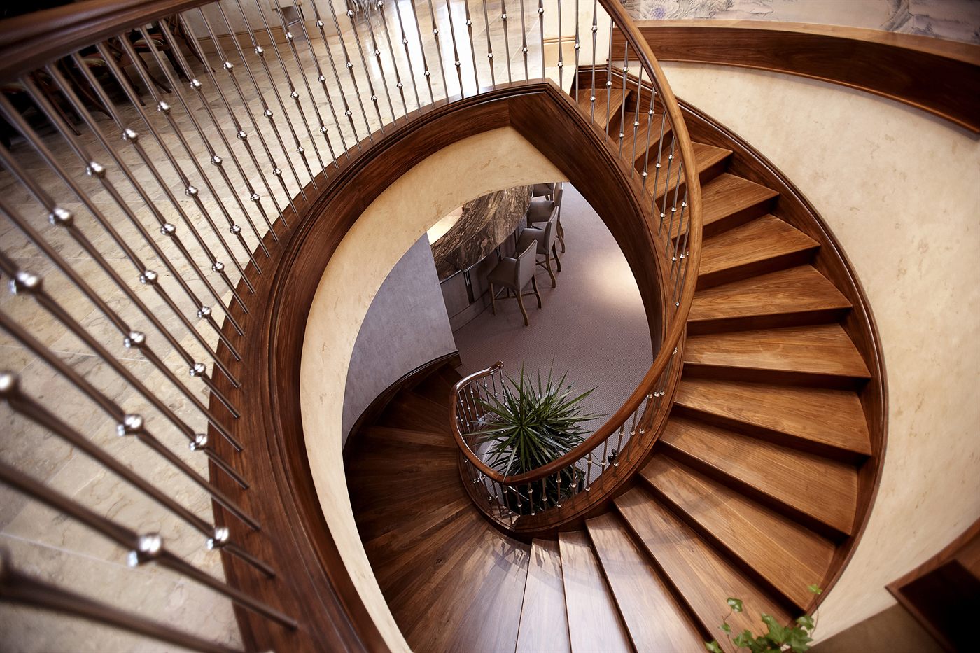 Custom curved hardwood staircase with metal balusters
